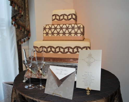 Square tiered cake with coordinating invitations and extras